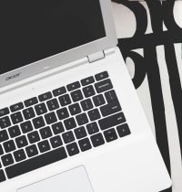 Stylish Acer laptop on a black and white geometric patterned surface, ideal for tech-themed concepts.