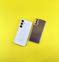 Two sleek smartphones on a bright yellow background, emphasizing modern technology and design.